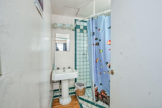 bathroom with a shower with curtain and hardwood / wood-style floors