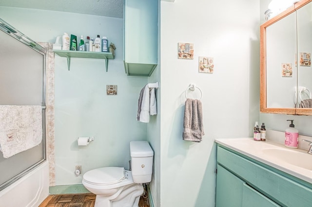 full bathroom featuring bath / shower combo with glass door, parquet flooring, vanity, and toilet