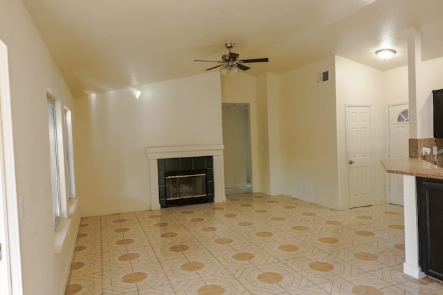 5140 E Belgravia Ave, Fresno, CA 93725 - unfurnished living room with a ceiling fan, a fireplace, light tile patterned floors, and lofted ceiling