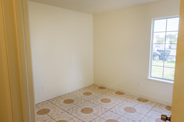 5140 E Belgravia Ave, Fresno, CA 93725 - empty room featuring baseboards and light tile patterned floors