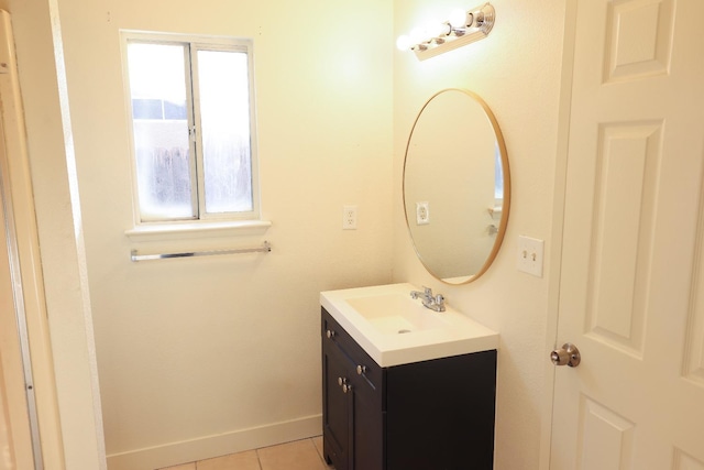 5140 E Belgravia Ave, Fresno, CA 93725 - bathroom with vanity, tile patterned flooring, and baseboards