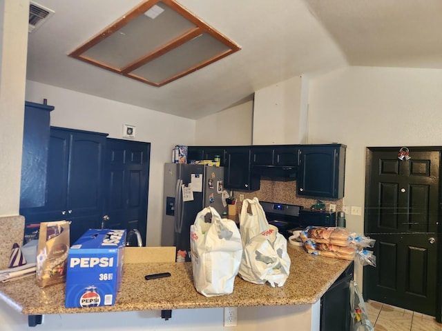 kitchen featuring lofted ceiling, light stone counters, black / electric stove, stainless steel fridge, and kitchen peninsula