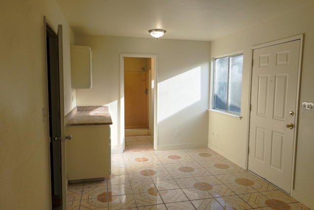 5140 E Belgravia Ave, Fresno, CA 93725 - foyer featuring light tile patterned floors and baseboards