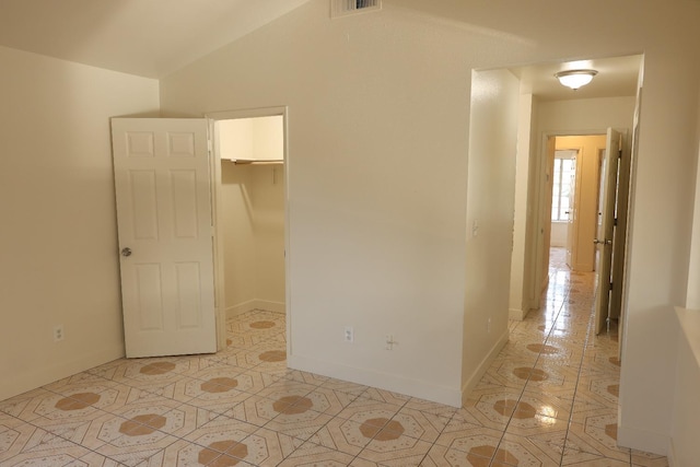 5140 E Belgravia Ave, Fresno, CA 93725 - unfurnished bedroom with light tile patterned flooring, a walk in closet, and baseboards