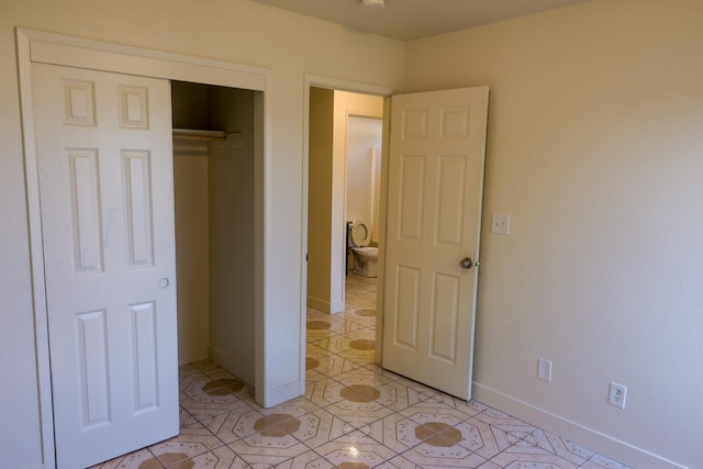 5140 E Belgravia Ave, Fresno, CA 93725 - bedroom featuring baseboards, light tile patterned floors, and a closet