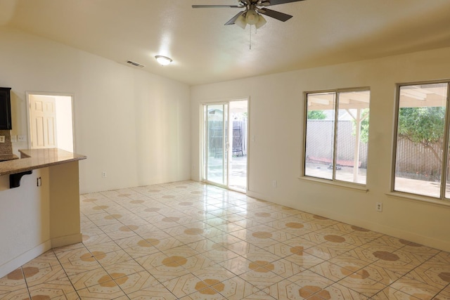 5140 E Belgravia Ave, Fresno, CA 93725 - unfurnished living room featuring ceiling fan, vaulted ceiling, and light tile patterned flooring