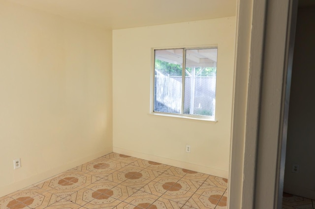 5140 E Belgravia Ave, Fresno, CA 93725 - empty room with baseboards and light tile patterned flooring