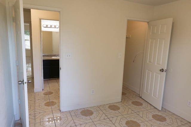5140 E Belgravia Ave, Fresno, CA 93725 - unfurnished bedroom featuring light tile patterned flooring and baseboards