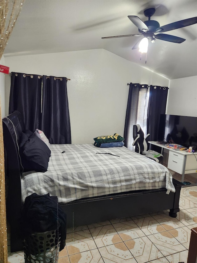 bedroom featuring vaulted ceiling, ceiling fan, and light tile patterned flooring