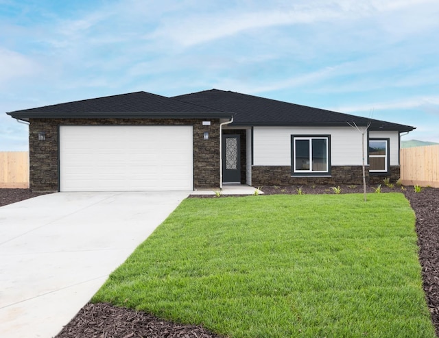 view of front of home with a garage and a front lawn