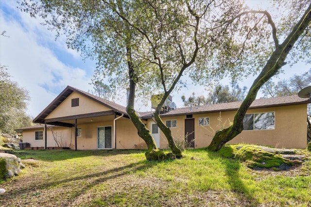 rear view of property with a yard