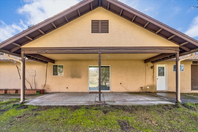 back of house with a patio