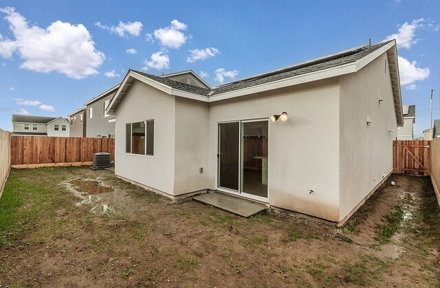 rear view of house with central air condition unit