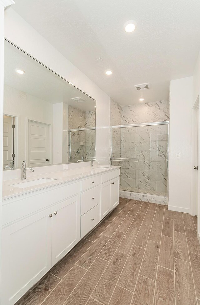 bathroom featuring vanity and a tile shower