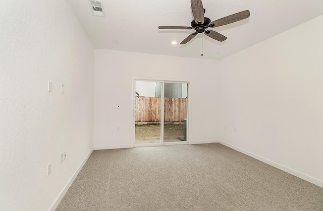 carpeted spare room featuring ceiling fan