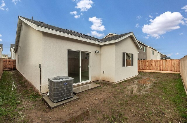 rear view of property featuring central air condition unit