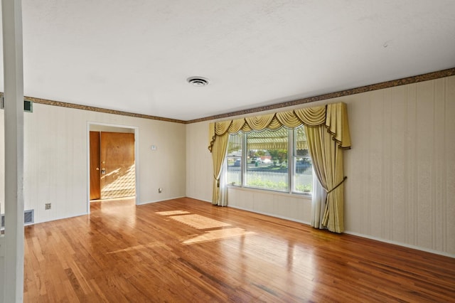 spare room with wood-type flooring