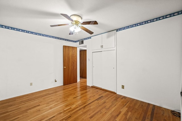 unfurnished bedroom with a closet, ceiling fan, and light hardwood / wood-style flooring