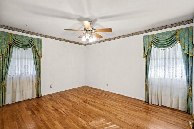 spare room featuring ceiling fan and light wood-type flooring