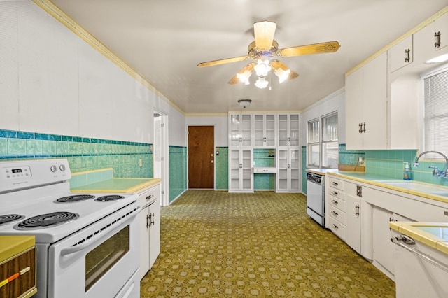 kitchen with dishwashing machine, sink, ceiling fan, white range with electric stovetop, and white cabinets