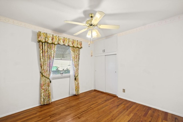 unfurnished room with ceiling fan and wood-type flooring