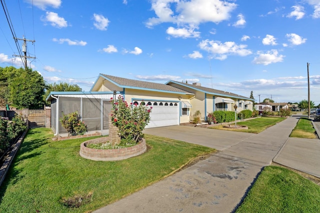 view of front of home with a garage and a front lawn