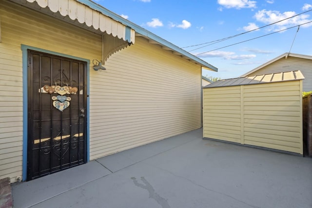 view of exterior entry with a patio area