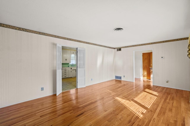 unfurnished room featuring hardwood / wood-style flooring