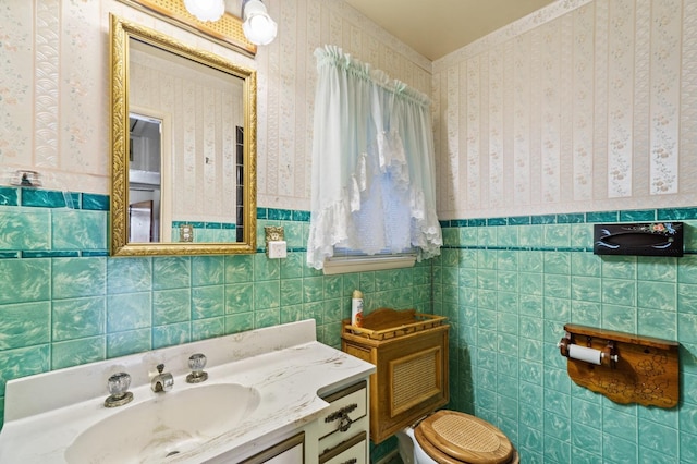 bathroom with vanity and tile walls