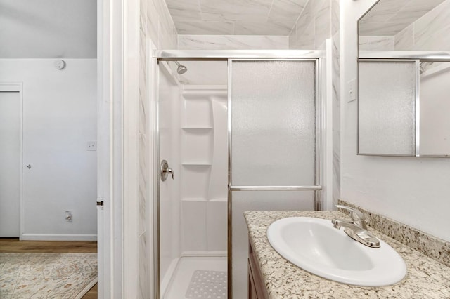 bathroom with vanity and a shower with shower door