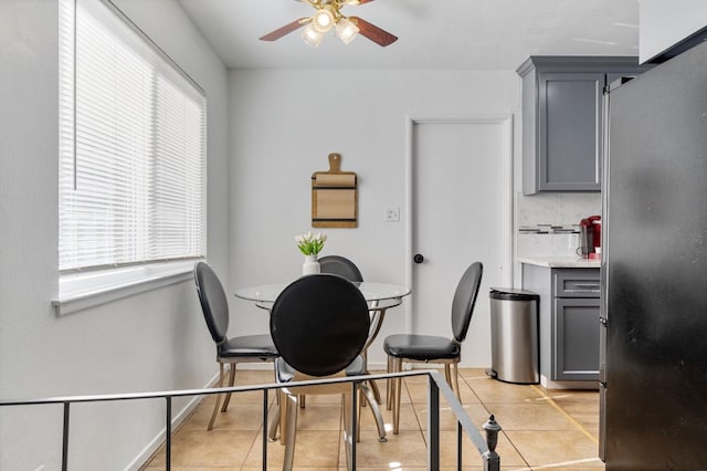 dining area featuring a healthy amount of sunlight, light tile patterned floors, and ceiling fan