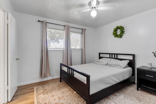 bedroom with ceiling fan and light wood-type flooring