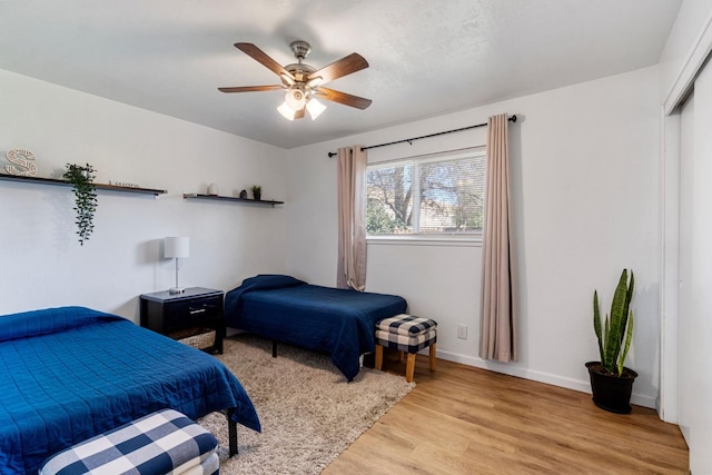 bedroom featuring a closet, ceiling fan, and light hardwood / wood-style flooring