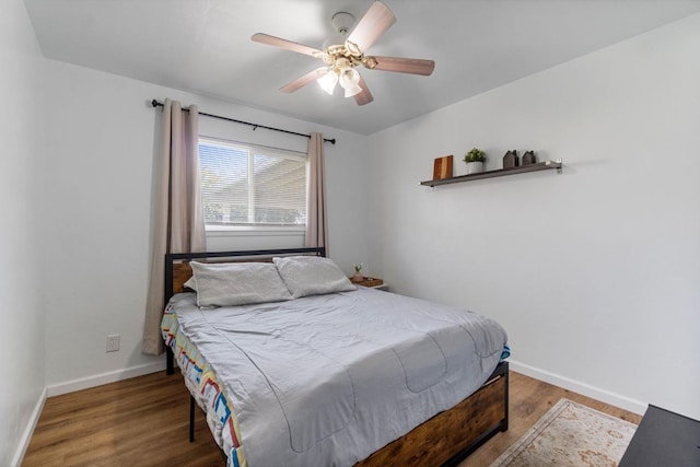 bedroom with dark wood-type flooring and ceiling fan