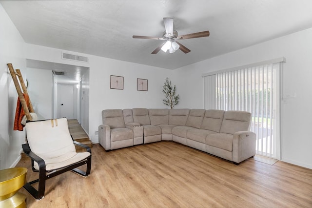 living room featuring light hardwood / wood-style flooring and ceiling fan