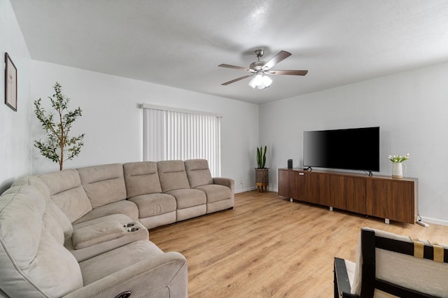 living room featuring ceiling fan and light hardwood / wood-style floors