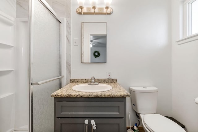 bathroom with vanity, toilet, and walk in shower