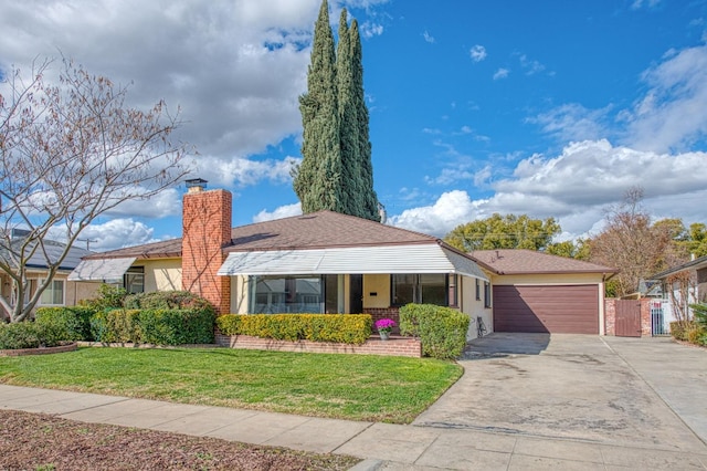 ranch-style house featuring a garage and a front yard