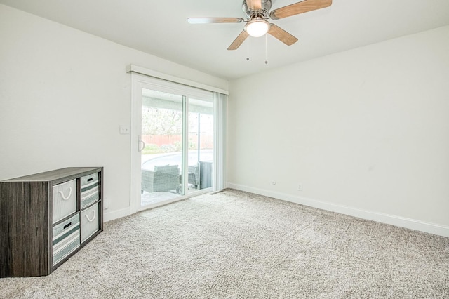 carpeted spare room featuring ceiling fan