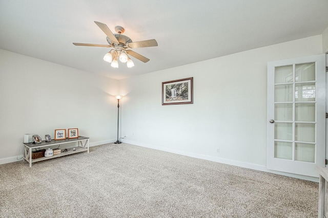 carpeted spare room with ceiling fan