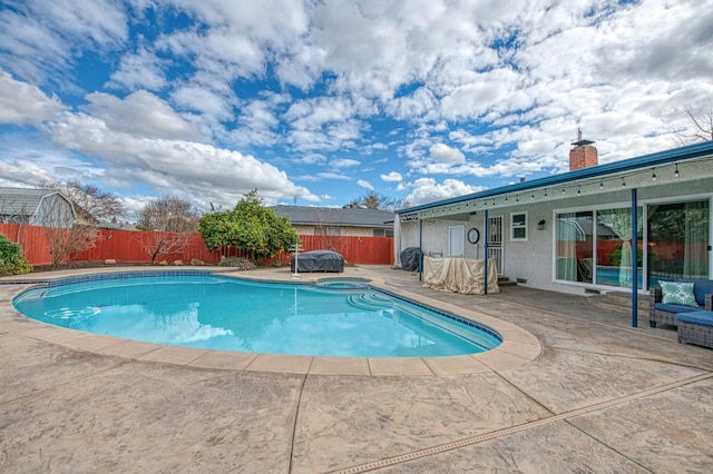 view of pool with a patio and an in ground hot tub