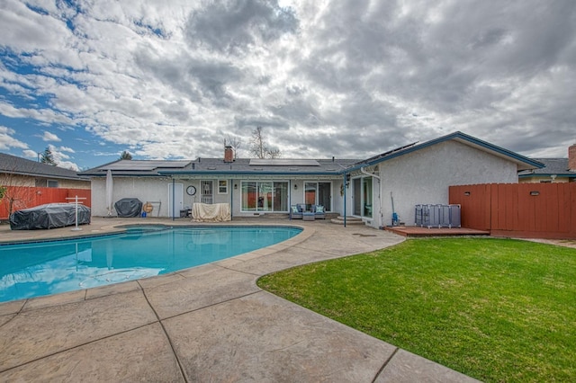 view of swimming pool featuring a patio area and a lawn