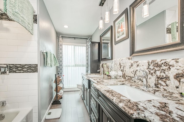 full bathroom with toilet, vanity, shower / washtub combination, hardwood / wood-style flooring, and decorative backsplash