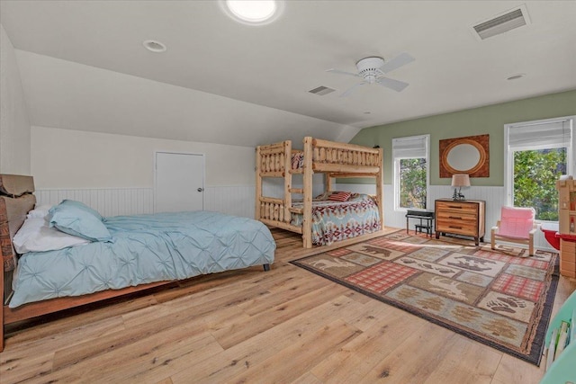 bedroom with lofted ceiling and light hardwood / wood-style floors