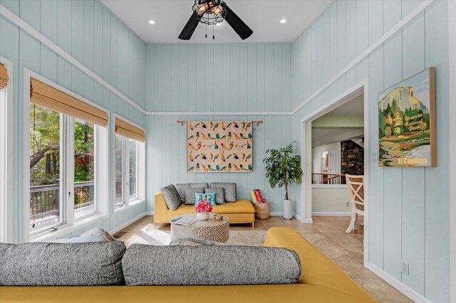 living room featuring a high ceiling and ceiling fan