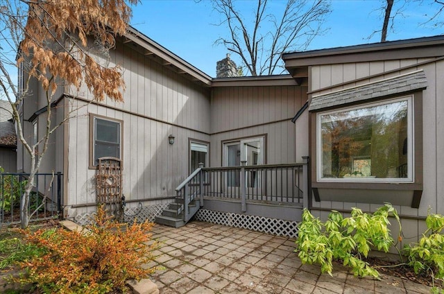 entrance to property with a patio area and a deck