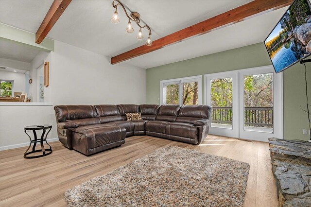 living room featuring light hardwood / wood-style floors and beamed ceiling