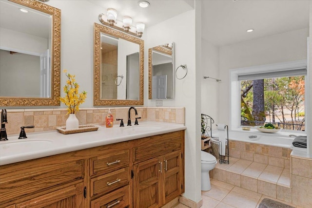 bathroom with tasteful backsplash, vanity, tile patterned flooring, and toilet