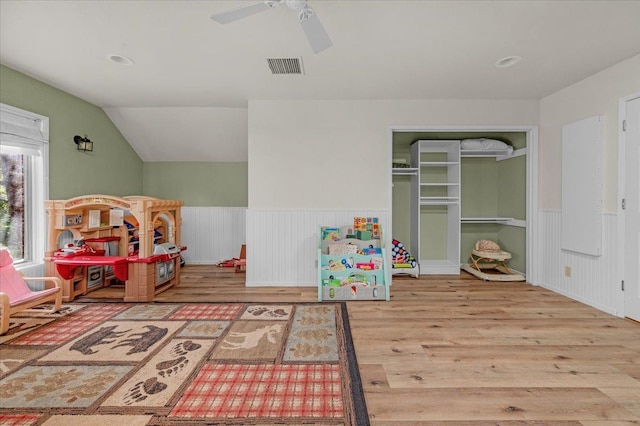 playroom with wood-type flooring, lofted ceiling, and ceiling fan