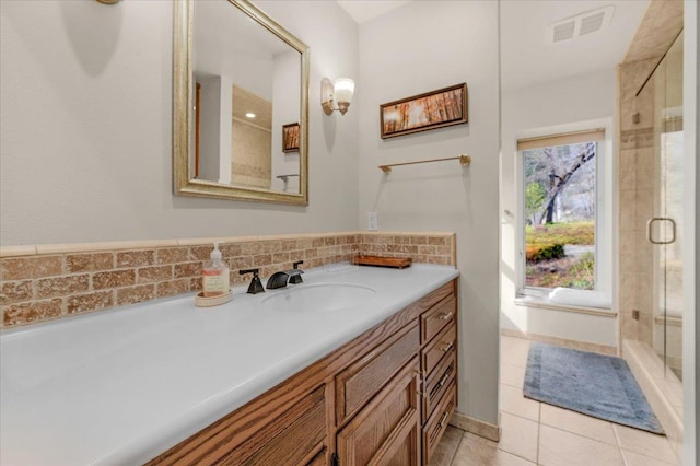 bathroom featuring vanity, tile patterned floors, and walk in shower